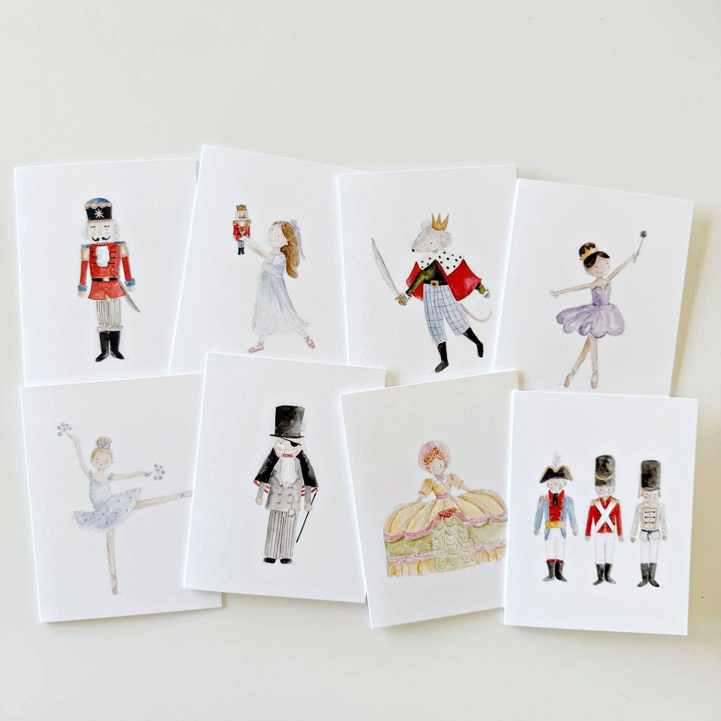 Set of eight Nutcracker greeting cards featuring watercolor ballet characters—soldiers, ballerina, king, and princess. Available in assorted sizes. Ideal for Christmas or holiday notes.