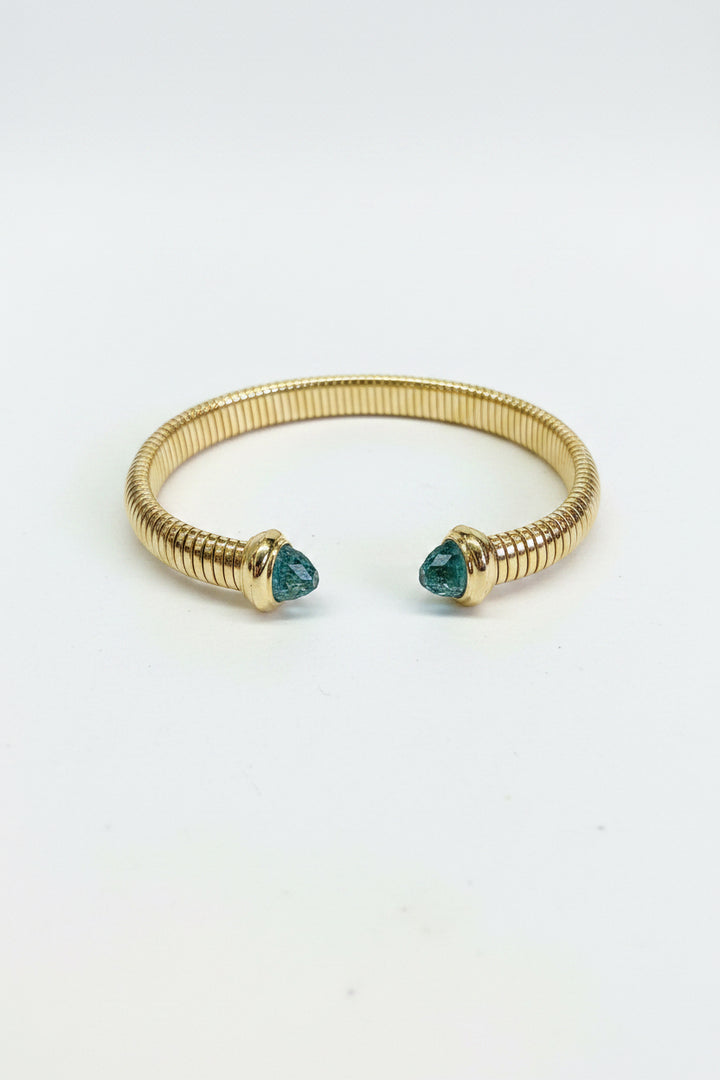Gold open cuff bracelet with ribbed design and teal gemstone ends, inspired by CZ bangles. Available in S/M/L.