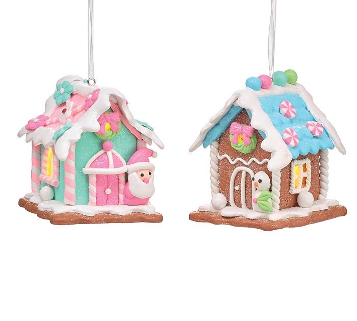Two lighted gingerbread house ornaments decorated with colorful icing, candy accents, and Santa or snowman figures.