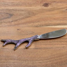 Antler Spreader Silver with a metal blade and antler-shaped handle.