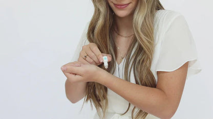 Keychain Mini Rollerball Perfume in a small bottle, available in multiple sizes, shown being applied to the wrist.