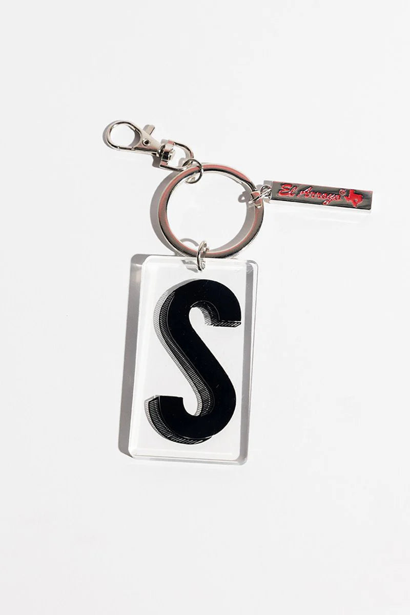 Large black "S" in clear acrylic, on a metal key ring with a small tag. Available sizes: standard.