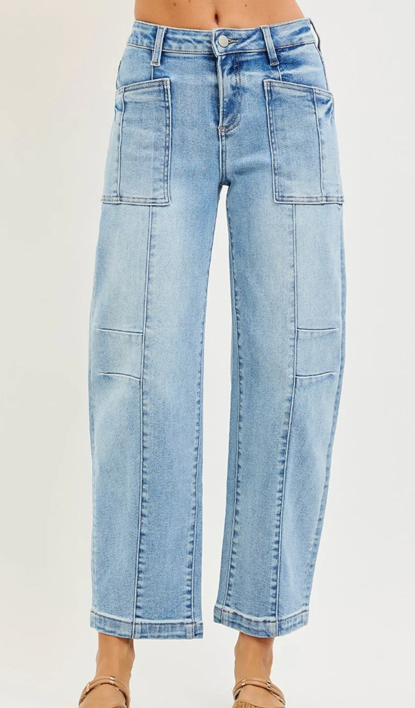Risen light wash blue barrel leg ankle boyfriend jeans with high-rise waist, patch pockets, and vertical seam detailing.