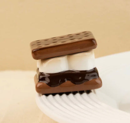 Nora Fleming Minis s'more with two marshmallows and chocolate between graham crackers; available in mini size.