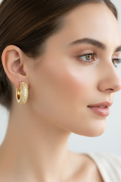 Elegant shimmery gold hoop earrings shown; available in small, medium, and large sizes.