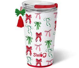 Swig 24oz Holiday Party Cup featuring a white pattern of red, pink, and green bows, an EZ Slider lid, and a decorative green bow and red tassel charm.