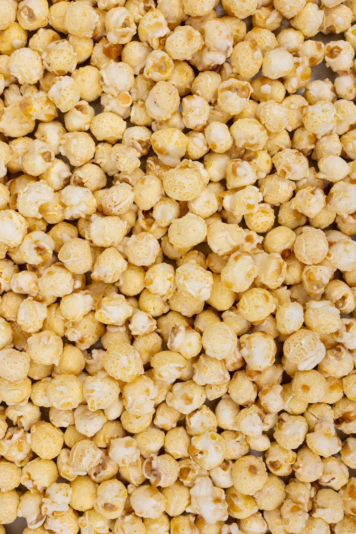 Funnel Cake Popcorn: yellow, buttered kernels with powdered sugar coating. Available in small, medium, and large sizes.