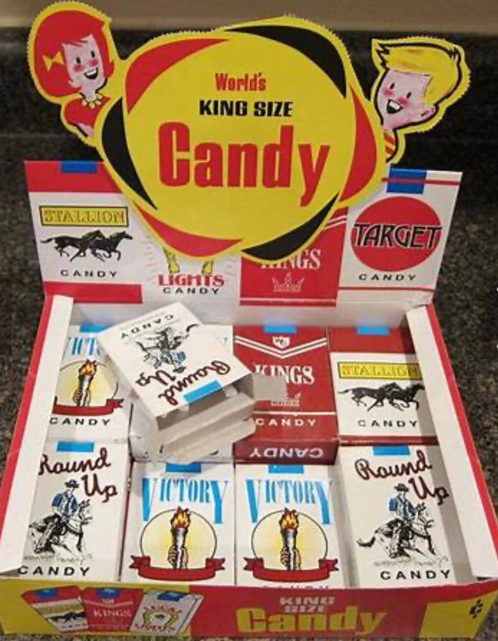 Yellow and red box of Nostalgic Old Fashioned Candy Cigarettes in retro packs; available in standard carton size.