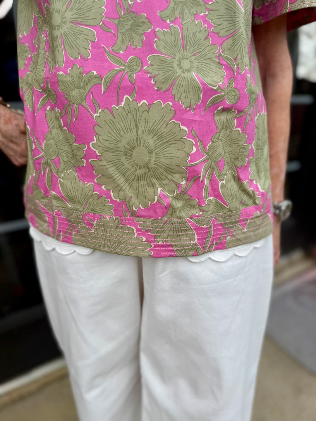 Ramona Garden District Green Top with floral pattern and ruffle V-neck blouse design. Available in sizes XS–XL.