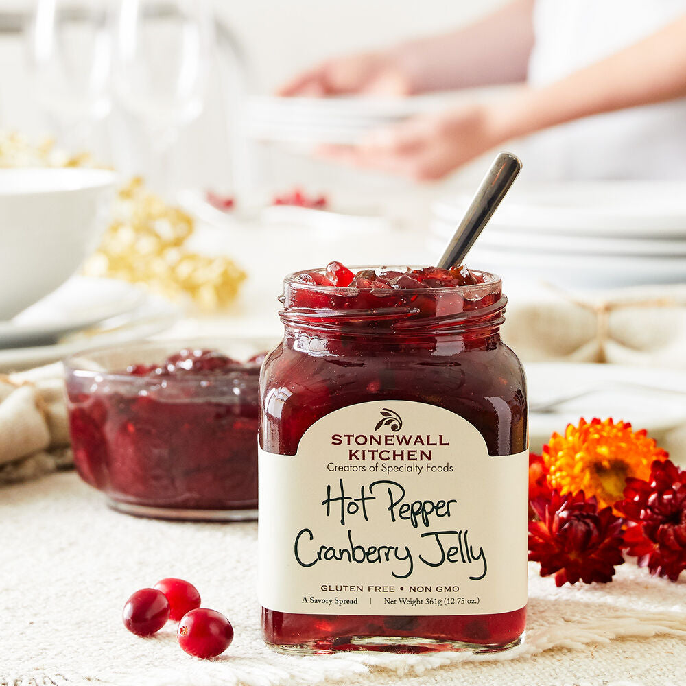 Hot Pepper Cranberry Jelly in an 8oz jar with a spoon. Available in 8oz and 16oz sizes.