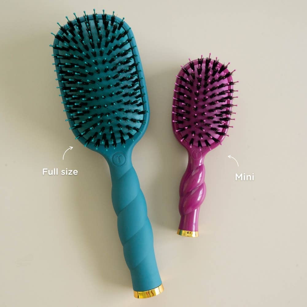 The Mini Boar Bristle Hair Brush in Mulberry is a compact, purple brush with natural boar bristles; available in a mini size.