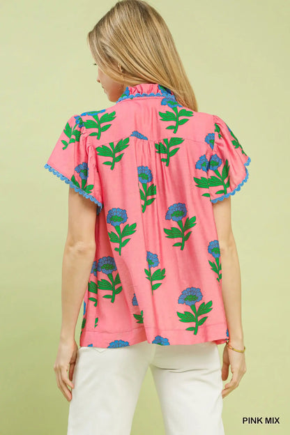 Pink floral button front ruffle sleeve top with blue and green floral print, blue lace trim on sleeves. Available in sizes XS-XL.
