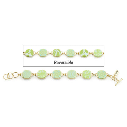 Palm Beach Reversible Coin Bracelet with linked square beads, Matte Gold plating. One side: Seaside Green with various patterns. Other side: Brighter green with floral motifs. T-bar clasp engraved with brand name. Available sizes: Small, Medium, Large.