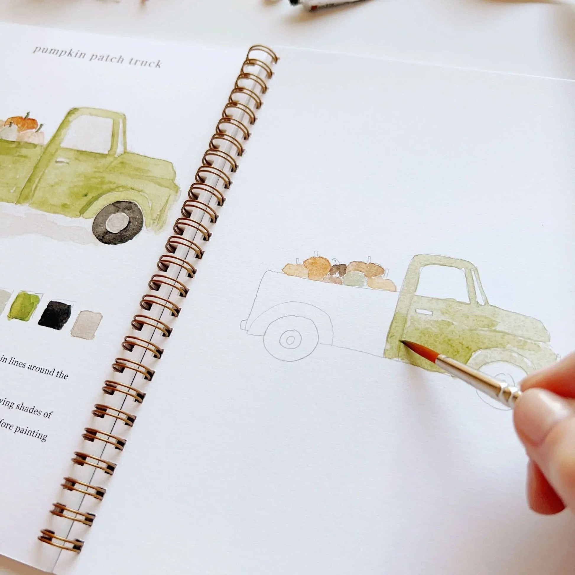 Autumn watercolor workbook with a hand-painted green pickup and pumpkins. Spiral-bound. Available in A4 and A5 sizes.