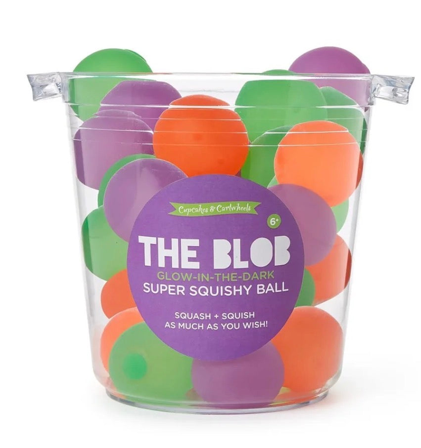 Green, orange, and purple Glow In The Dark Blob Squishy balls in a transparent bucket. For ages 6+. Glows in the dark. Available sizes: not specified.