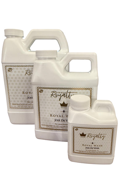 Bourbon Royalty Royal Wash laundry detergent in white bottles with gold crown logo, available in three sizes.
