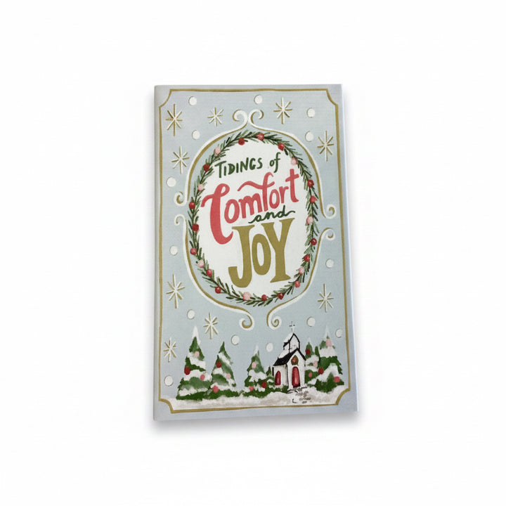 Multicolor Canvas Book Storage Box with snowy village scene, pine trees, and “Tidings of Comfort and Joy” wreath design.
