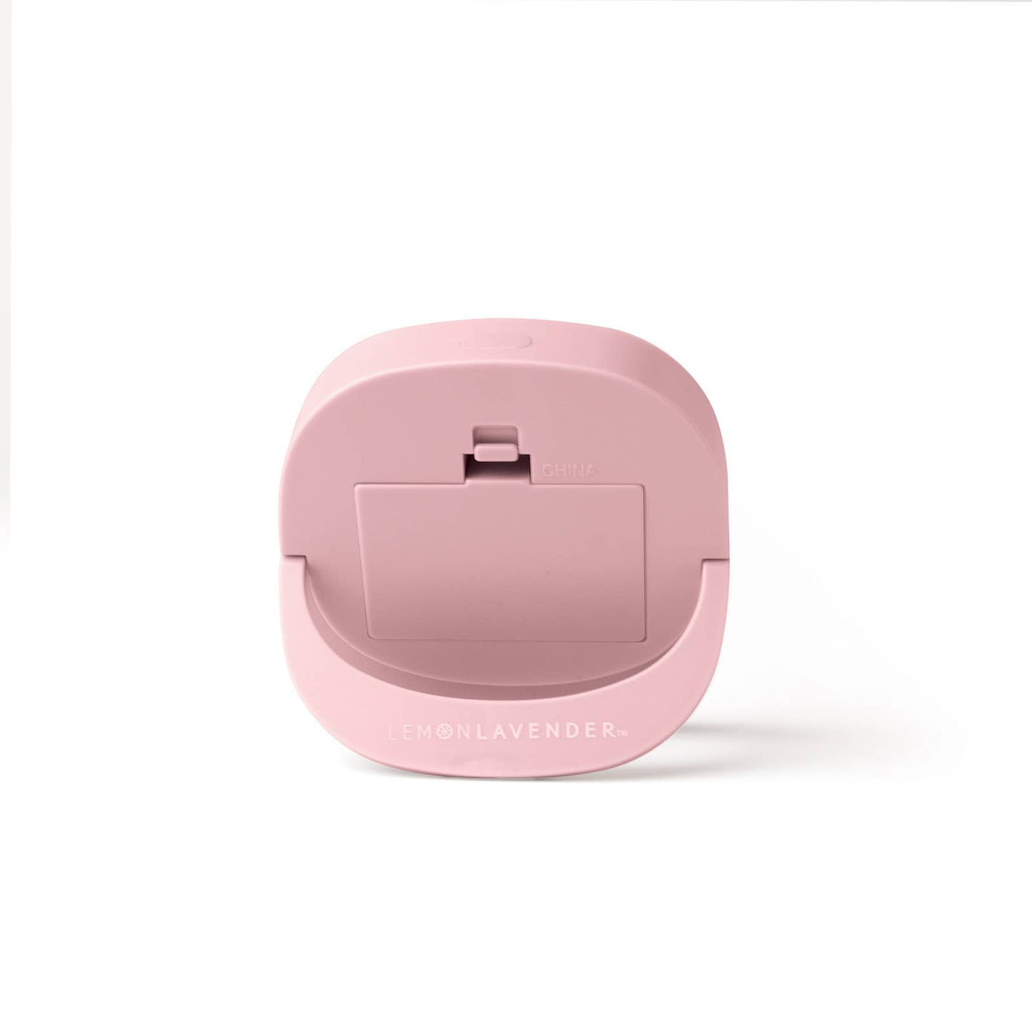 The product is a pink compact LED light-up mini mirror labeled "Lemon Lavender." This round makeup mirror comes with a clip on the back for easy attachment. The item is made from durable plastic and features a light proportion, making it travel-friendly. It has "China" inscribed on it denoting its origin.