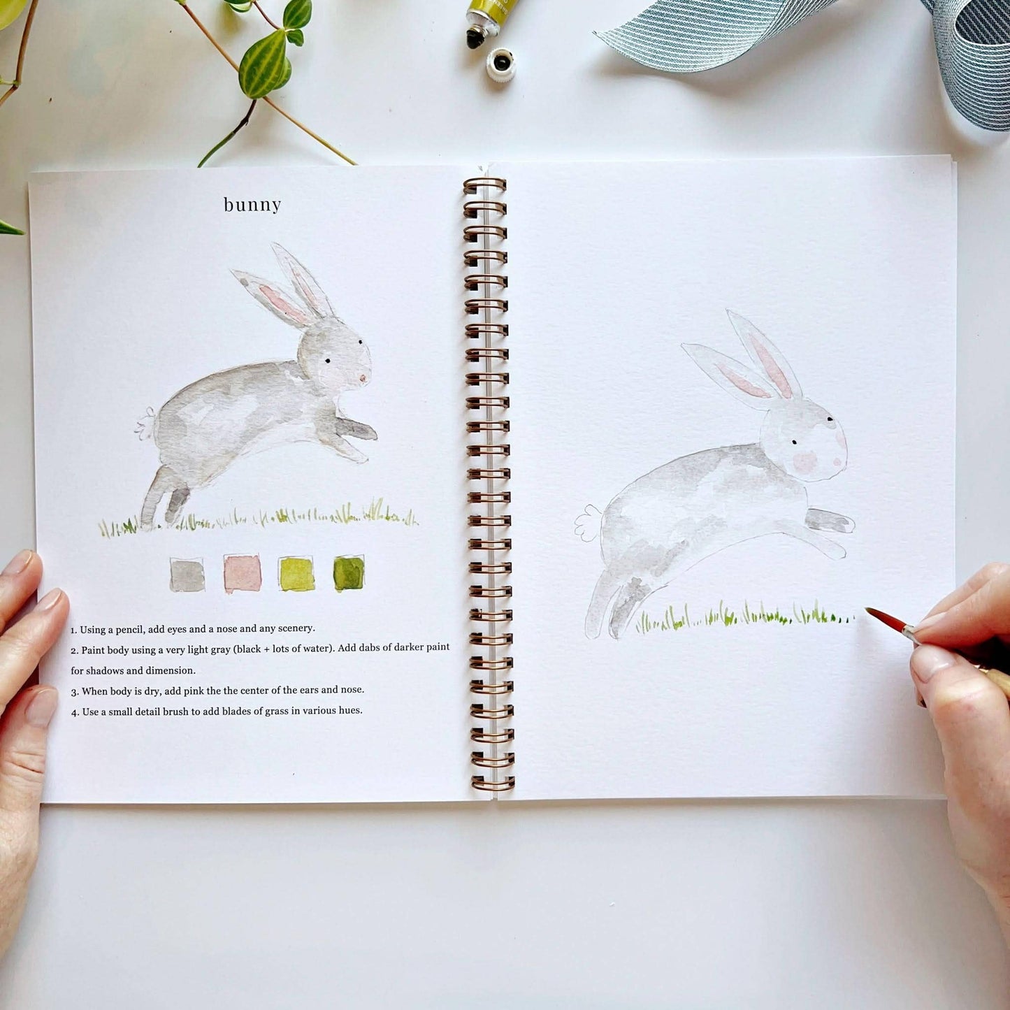 The Animals Watercolor Workbook, open to painting instructions and animal art. Available in standard and large sizes.