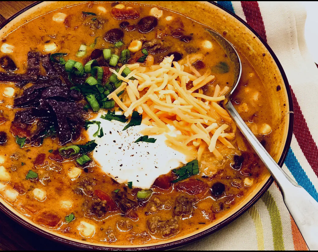 Tasty Taco Soup Mix with corn, beans, and tomatoes, topped with cheese and green onions. Available in 12oz and 24oz sizes.