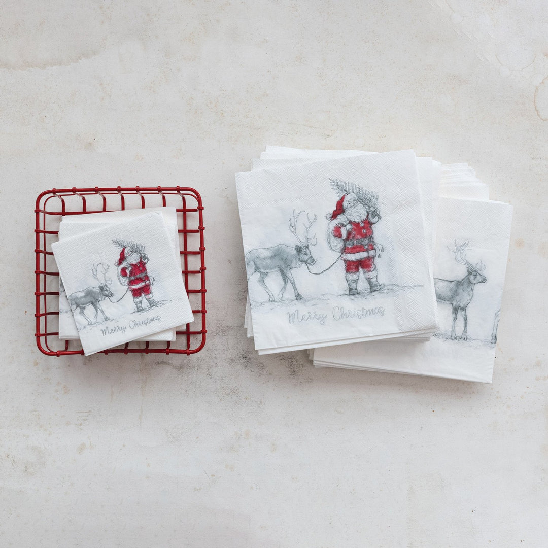 White paper napkins featuring a Santa and reindeer sketch with “Merry Christmas” text.