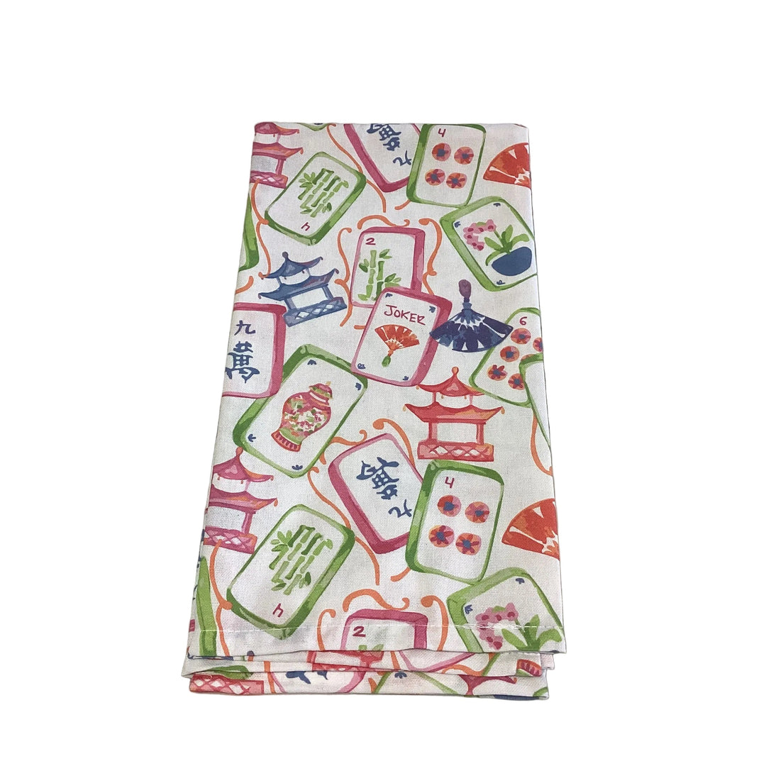Folded Mahjong Dreams Hand Towel featuring colorful mahjong tiles, pagodas, and fans.