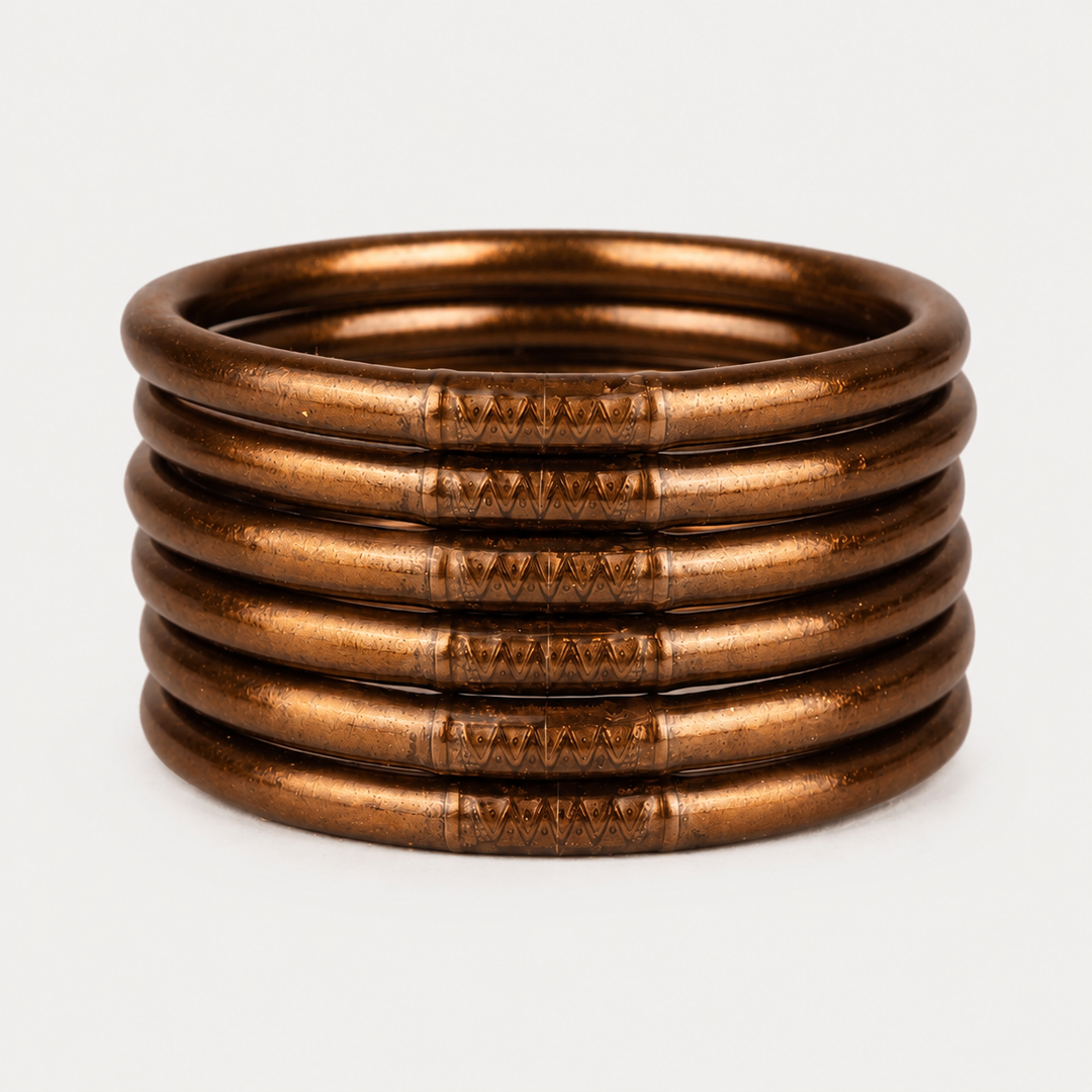 Six Saddle All Weather Bangles with engraved side patterns, available in multiple sizes.