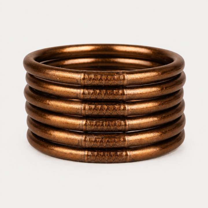 Six Saddle All Weather Bangles with engraved side patterns, available in multiple sizes.