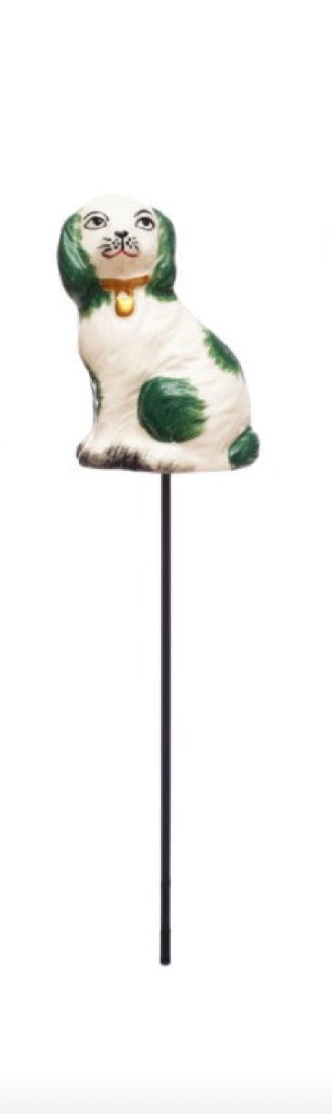 Hand-painted white and green dog figurine with a bell around its neck on a plant stake. Available in small and large sizes.