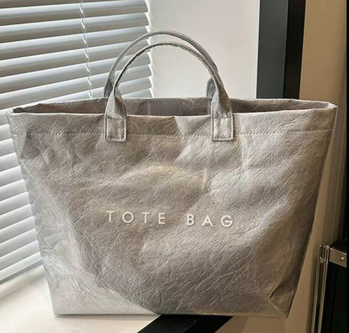 Metallic silver Vintage Tote Bag with two handles, bold white "TOTE BAG" lettering. Available in small, medium, large.