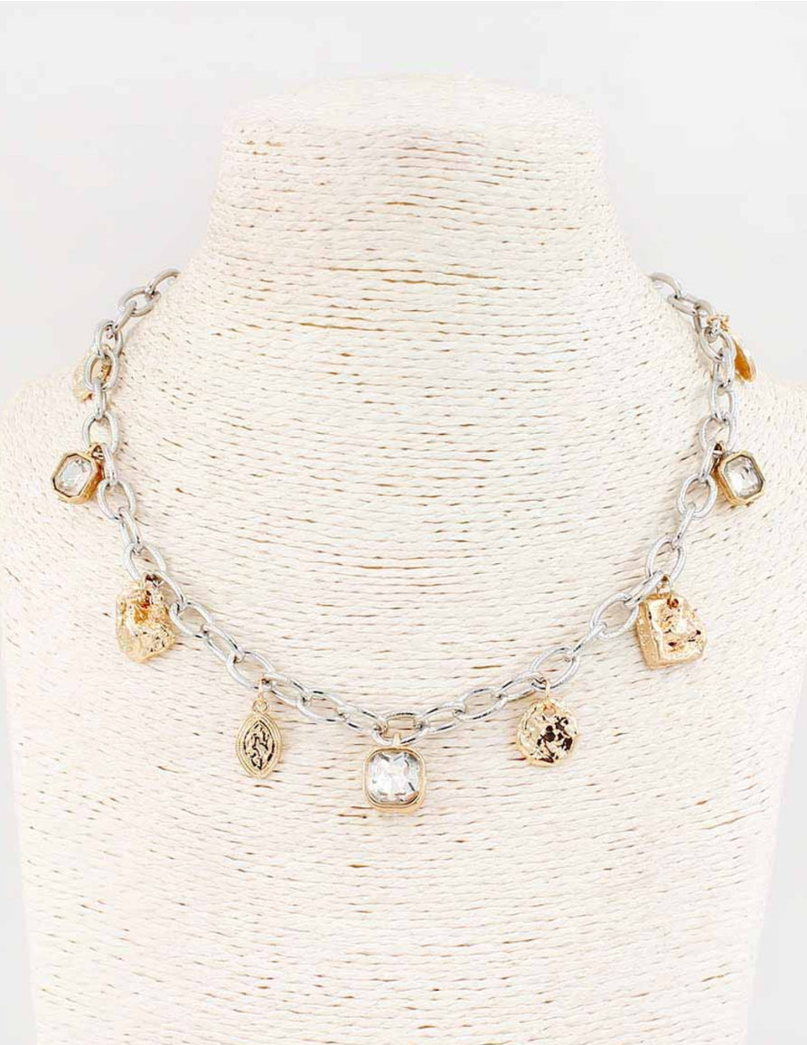 The Brim Gold Silver Necklace features irregular gold and silver charms on a chain-link design. Available in 16" and 18".