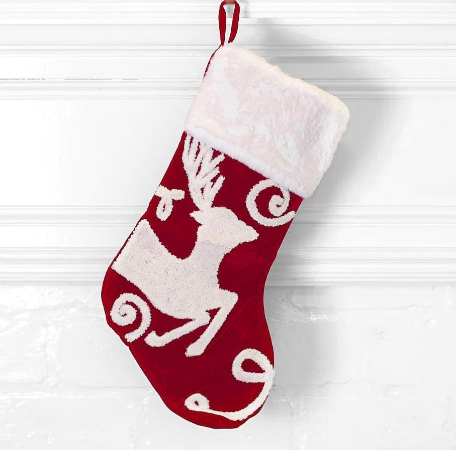 Red reindeer embroidered stocking with a white faux-fur cuff.