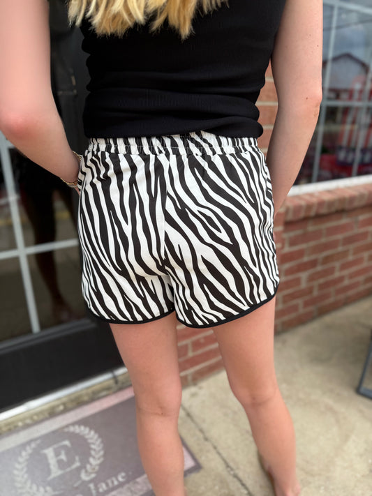Zebra Essence Everyday Shorts shown; available in sizes XS–XL.