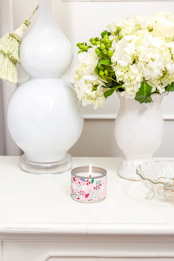 Lit Brambleberry 4oz candle in a round pink botanical tin.