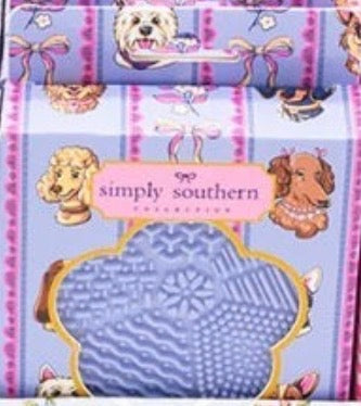 Lavender Simply Southern Makeup Brush Cleanser box with playful dog illustrations, a clear window showing the textured silicone cleaning pad inside; available in one size.