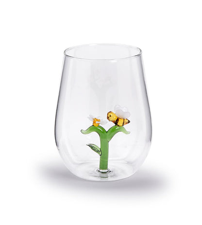 20 oz stemless wine glass with a green flower, yellow bee on one petal, and a white flower attached at the bottom.