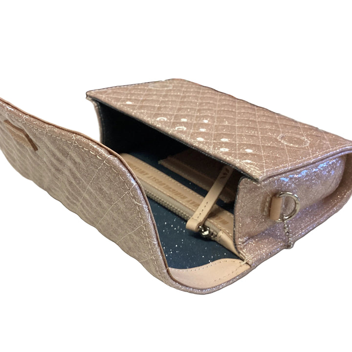 On The Town, Ori light pink quilted glitter mini messenger bag with fold-over magnetic closure and interior zip pocket.