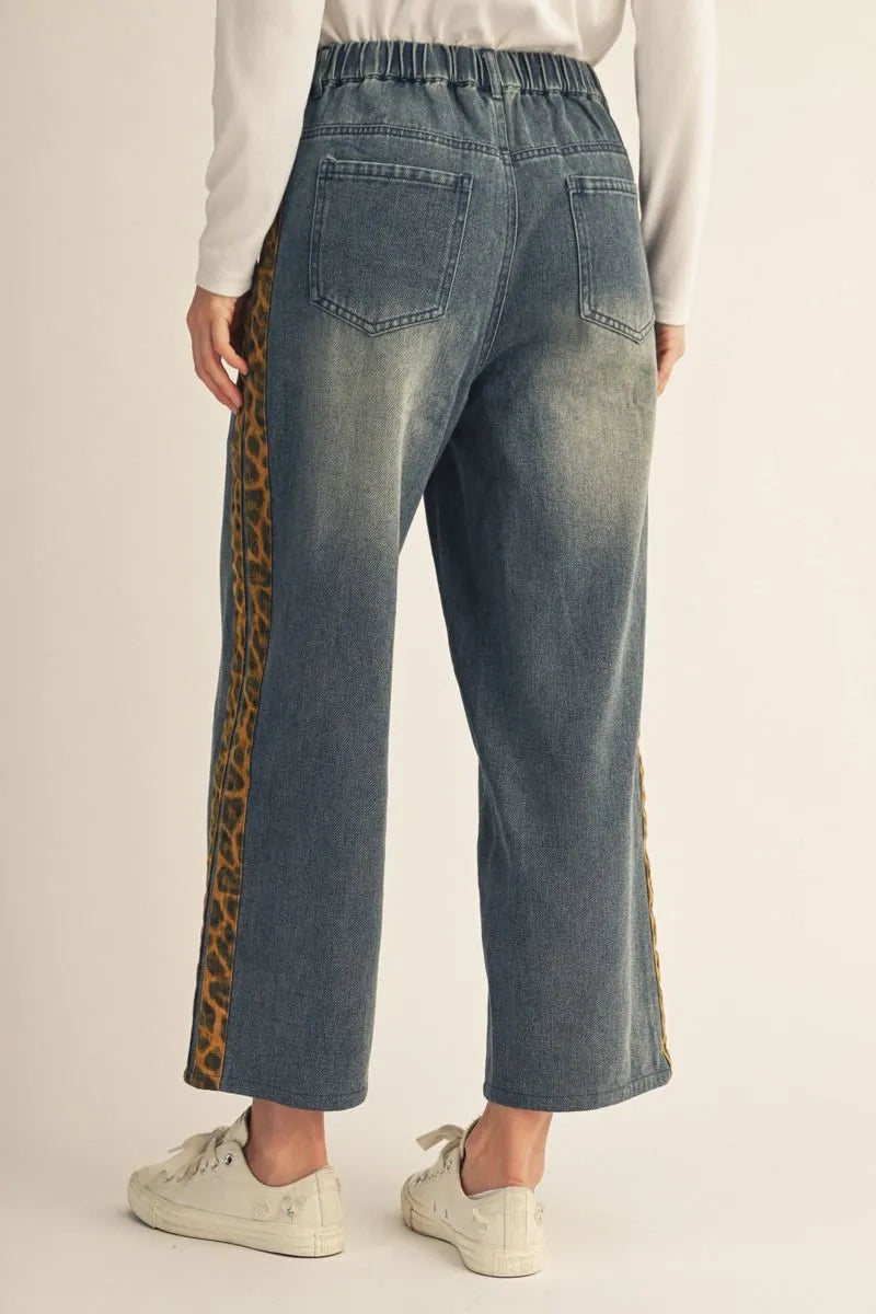 Cheetah Contrast Jeans: loose washed denim with animal-print stripes along the sides. Available in sizes XS–XL.