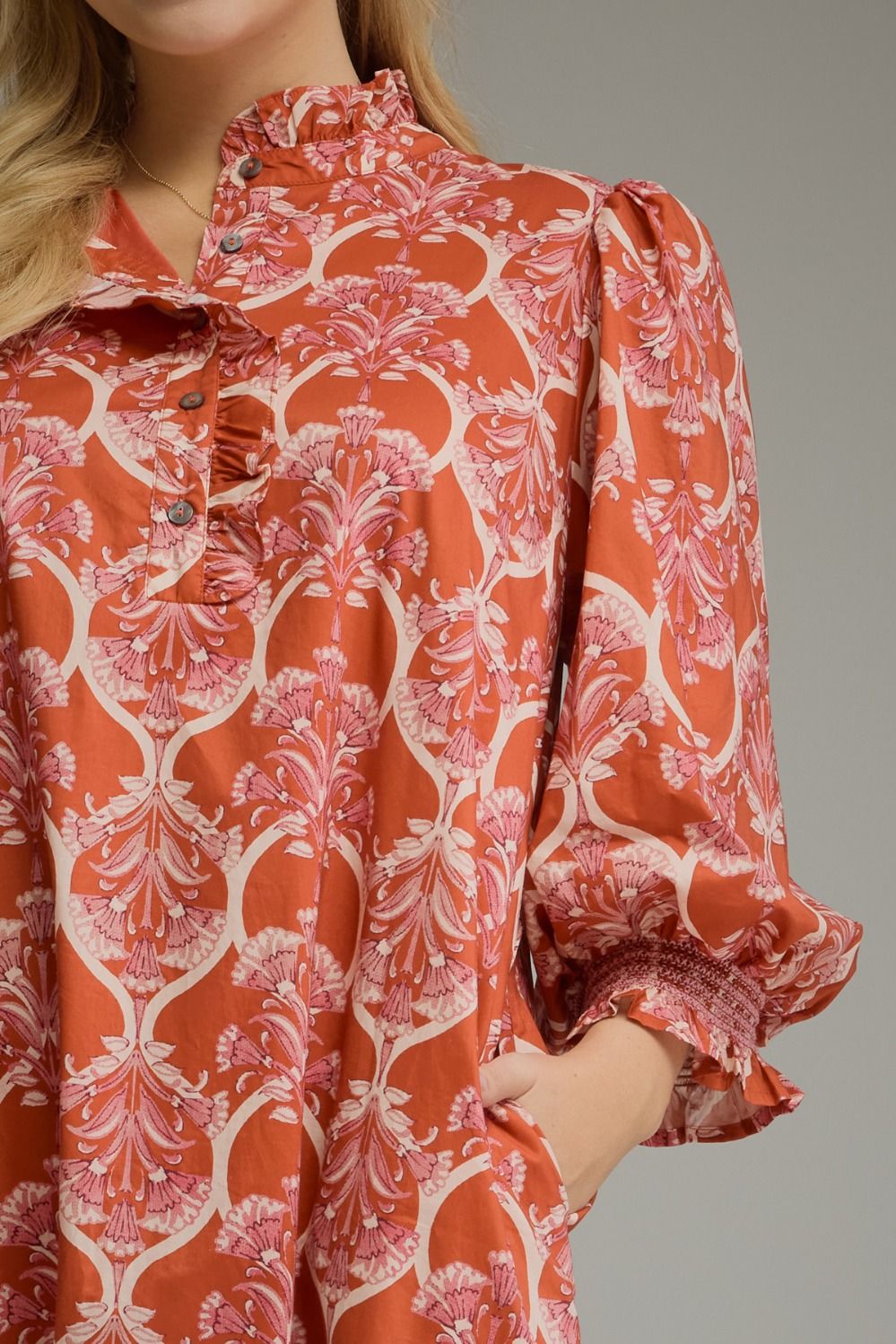 Nora Ruffle Midi Dress in orange and pink floral print with ruffled high collar, button-up placket, and balloon sleeves with smocked cuffs.