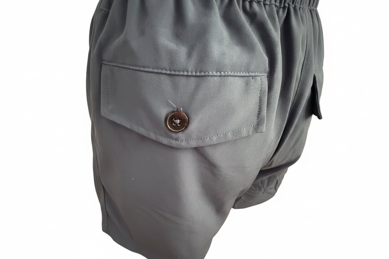 Men’s Khaki Drawstring Shorts with buttoned flap side pocket, shiny fabric, visible stitching, elastic waistband. Sizes S-XXL.