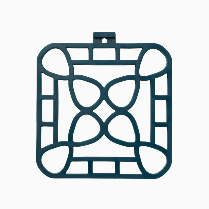 Dark green square trivet with geometric cutouts and a hanging loop. Heat-resistant. Available in 7" and 9" sizes.