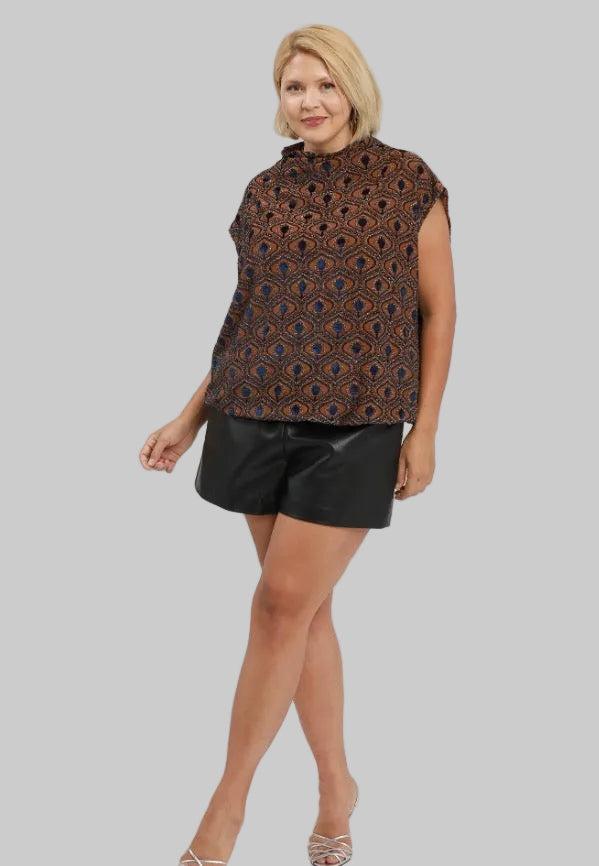 Rust velvet mock neck top with cap sleeves in a rust and navy blue patterned fabric.
