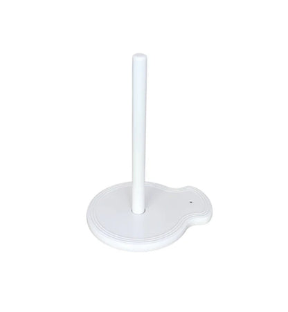 The "Paper Towel Holder Pinstripes" by nora fleming features a white design with a round base and a single vertical rod in the center. The base includes a small, curved extension on one side for added functionality and charm. Sizes available: N/A (one size fits all standard paper towel rolls).