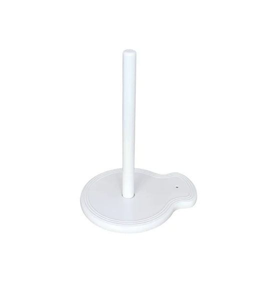 The "Paper Towel Holder Pinstripes" by nora fleming features a white design with a round base and a single vertical rod in the center. The base includes a small, curved extension on one side for added functionality and charm. Sizes available: N/A (one size fits all standard paper towel rolls).