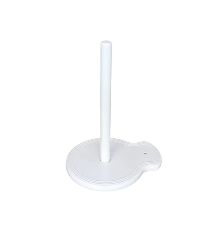 The "Paper Towel Holder Pinstripes" by nora fleming features a white design with a round base and a single vertical rod in the center. The base includes a small, curved extension on one side for added functionality and charm. Sizes available: N/A (one size fits all standard paper towel rolls).