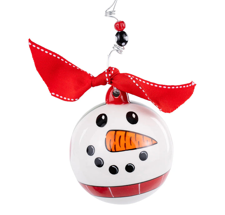Round white snowman ornament with painted face, red ribbon bow, and wire hanger.