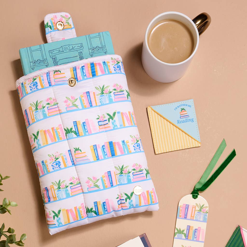 Fabric book sleeve with colorful bookshelf print. Available in small, medium, and large sizes.