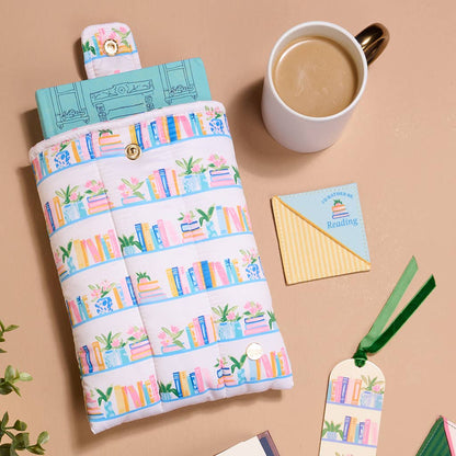 Fabric book sleeve with colorful bookshelf print. Available in small, medium, and large sizes.