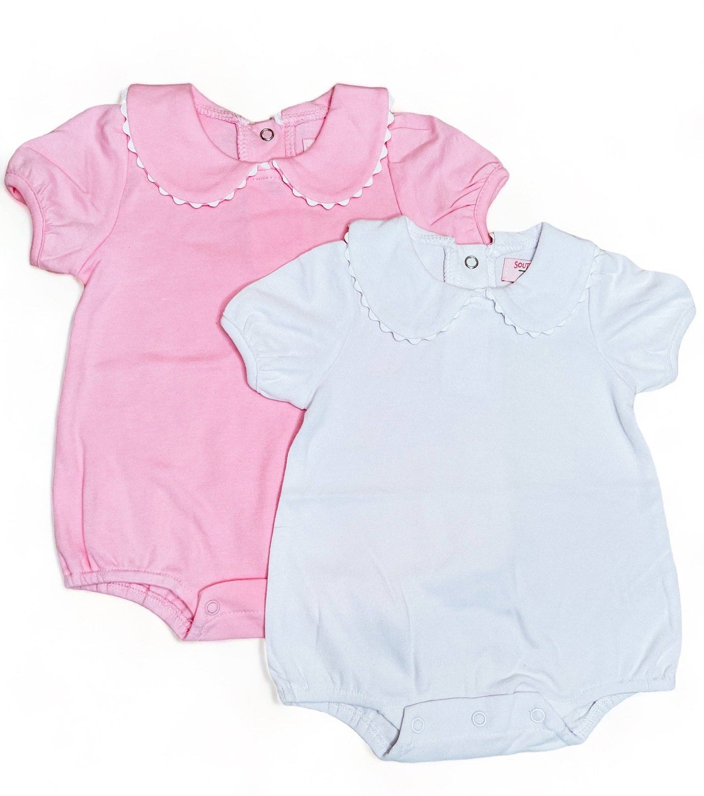 Two White Collared Baby Bubble Sleeve Onesies on a white background; one is pink with a scalloped collar, and the other is light blue, also with a scalloped collar, both made of 100%