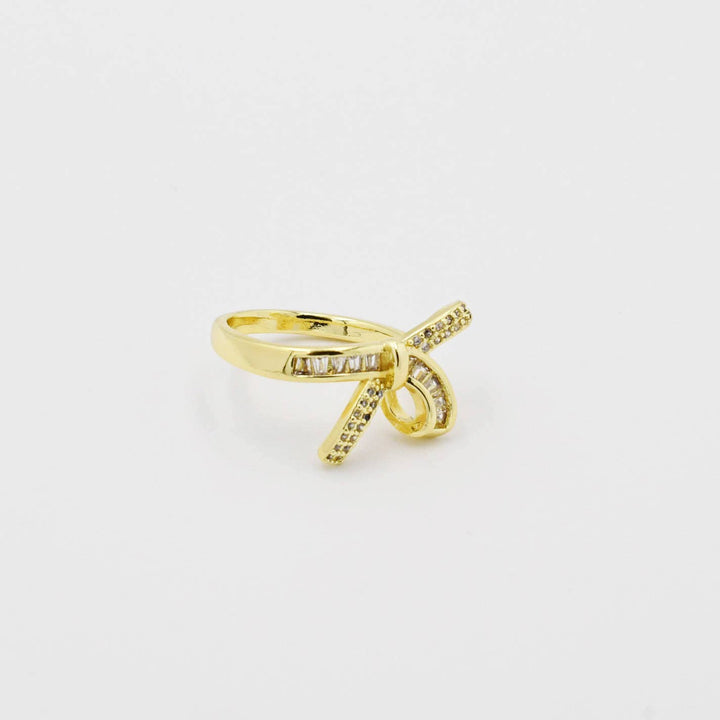 Gold-plated crisscross ring with clear pave stones; available in sizes 6, 7, and 8.